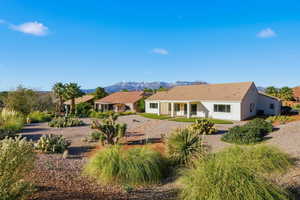 Back of house with a patio and a mountain view