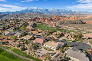 Aerial view of residential area featuring mountains and a local golf course