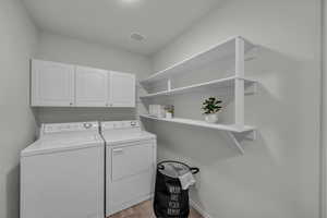 Laundry area featuring washing machine and dryer and cabinet space