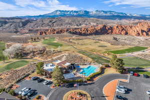 Bird's eye view of a mountainous background and a golf course