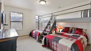 Bedroom featuring light carpet and baseboards