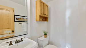 Half bath featuring a sink and toilet