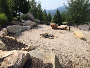 View of yard featuring a mountain view and a fire pit