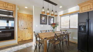 Dining room with plenty of natural light, stone tile flooring, and recessed lighting