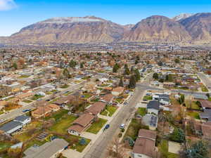 Aerial view of property's location with nearby suburban area and a mountain backdrop