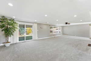 Unfurnished living room featuring light carpet, recessed lighting, and a ceiling fan