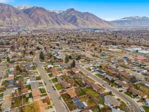 Aerial view of property and surrounding area with nearby suburban area