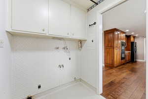 Laundry area featuring gas dryer hookup, wallpapered walls, electric dryer hookup, electric panel, and recessed lighting