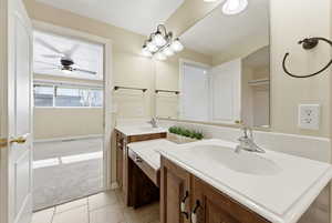 Full bathroom with double vanity, light carpet, and light tile patterned flooring