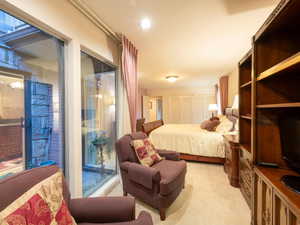 Primary bedroom with sitting area next to atrium