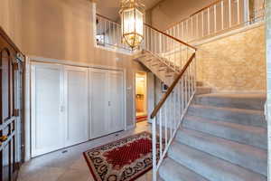 Entry way with beautiful staircase and chandelier