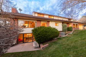 Backyard view of home with walkout basement and patio