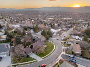 Aerial view of property's location featuring nearby suburban area and a mountain backdrop