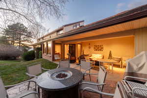Backyard with patio, firepit, furniture, and views out west