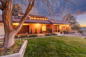 Front of home with mountain backdrop and valley views