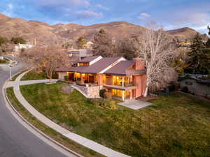 Aerial view of home with mountain backdrop and .43 acre yard