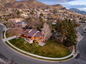 Aerial view of property and surrounding area featuring a mountain backdrop