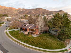 Aerial view of home with mountain backdrop