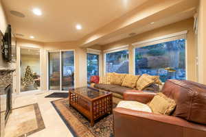 View of sunroom / family room with sliding doors out to back patio and beautiful backyard