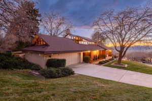 Aerial view of front of home at dusk looking over city