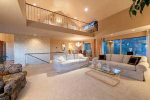 Spacious living room with beautiful city views, vaulted ceiling, dining area and reading loft above