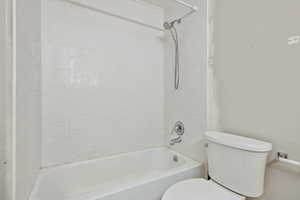 Full bathroom with shower / tub combination and toilet