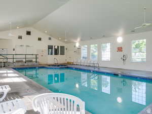 Indoor pool with a ceiling fan and a sink