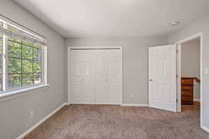 Unfurnished bedroom featuring carpet floors, a closet, and a textured ceiling