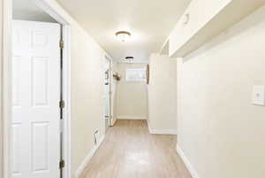Hallway featuring baseboards and light wood-type flooring