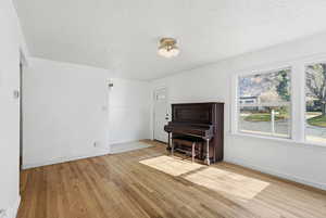 Living room featuring a textured ceiling and light wood finished floors