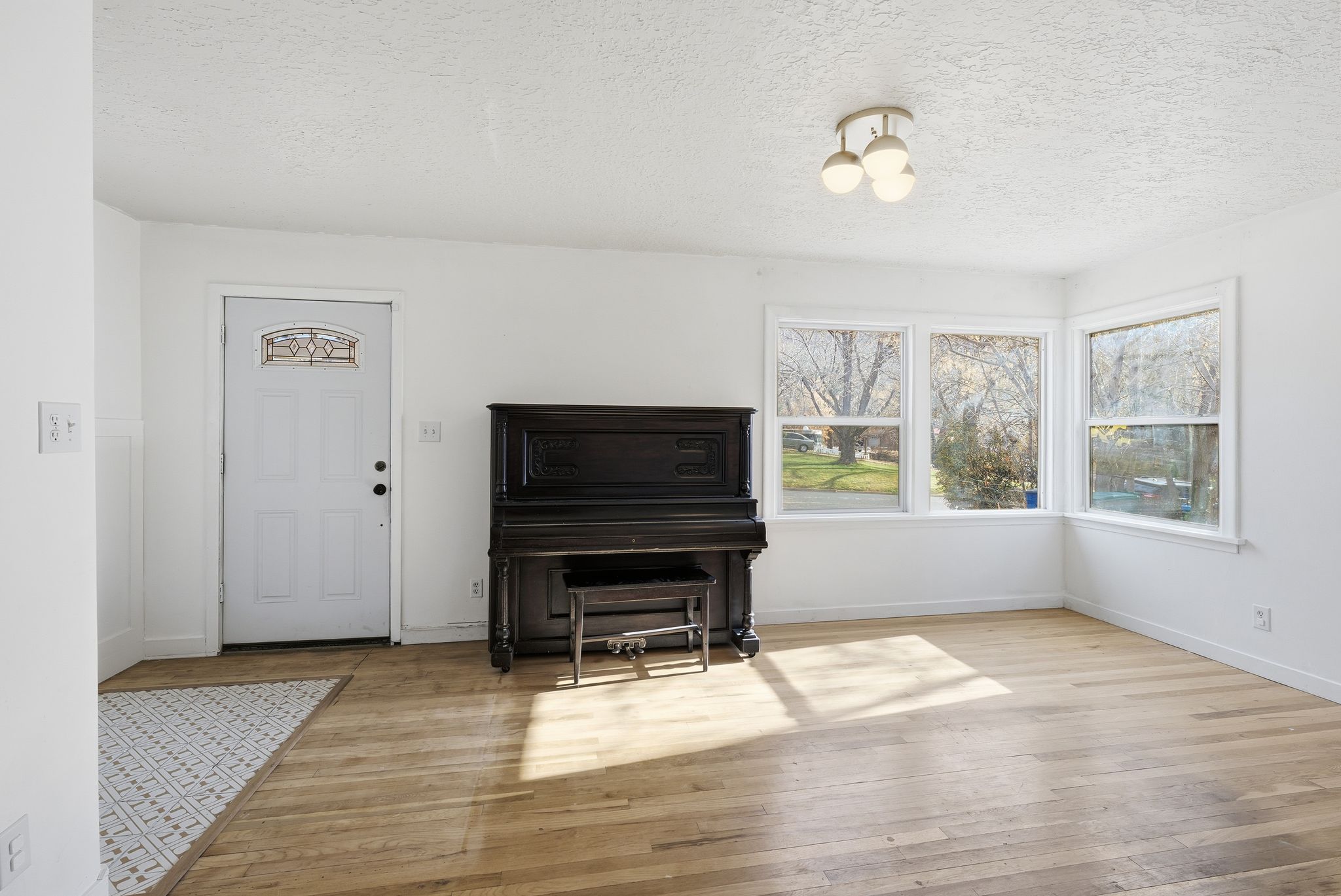 Sitting room featuring a textured ceiling and light wood-style floors