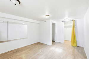 Empty room with light wood-style flooring and baseboards