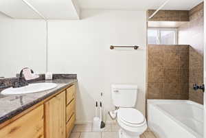 Bathroom featuring vanity, light tile patterned floors, and shower / bathtub combination