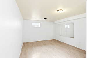 Spare room with light wood-type flooring and baseboards