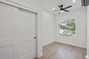Unfurnished bedroom with light wood finished floors, recessed lighting, a closet, and a ceiling fan