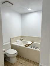 Bathroom featuring a bath and recessed lighting