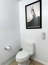 Bathroom featuring baseboards and light tile patterned floors