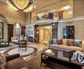 Community lobby featuring a high ceiling, ornamental molding, and recessed lighting