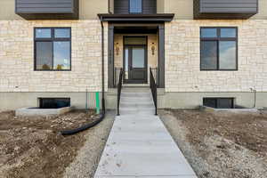 Property entrance featuring stone siding