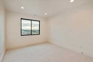 Unfurnished room featuring light carpet and recessed lighting