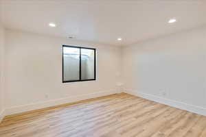Unfurnished room featuring light wood finished floors and recessed lighting