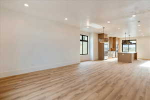 Unfurnished living room featuring light wood-style flooring and recessed lighting