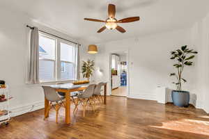 Dining room with healthy amount of natural light, wood finished floors, and a ceiling fan