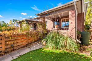 View of front of house with brick siding and ceiling fan