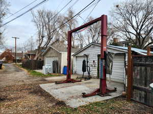 Back of property featuring an outdoor structure and a garage