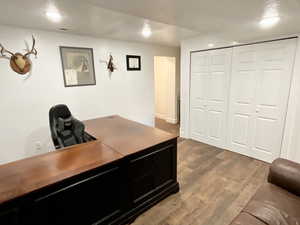 Office space featuring dark wood finished floors and recessed lighting