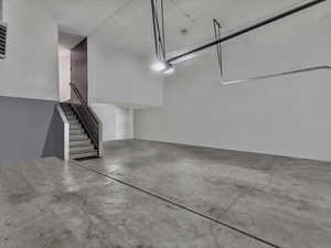 View of huge garage, fits 3 cars.. and its heated! (Virtually empty image)