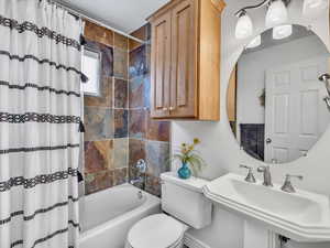 Full bathroom featuring shower / bath combo and toilet