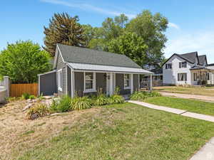 Bungalow with covered porch and a shingled roof