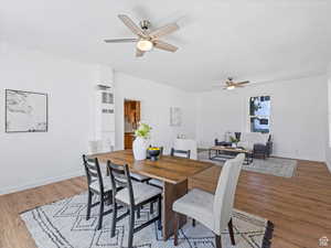 Dining space featuring a heating unit, light wood-style flooring, and a ceiling fan